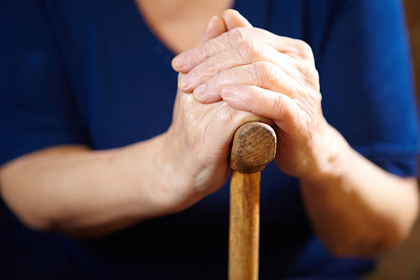istock Old woman hands with cane 527656311