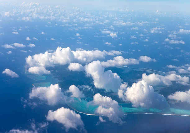 istock Polynesia. The atoll in ocean through clouds. Aerial view. 527657025
