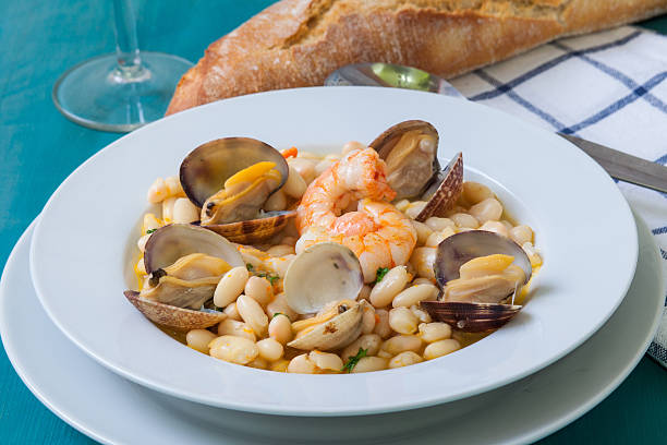 Beans and clams fabes con almejas is a homemade beans and clams seafood from spain culture fabes stock pictures, royalty-free photos & images