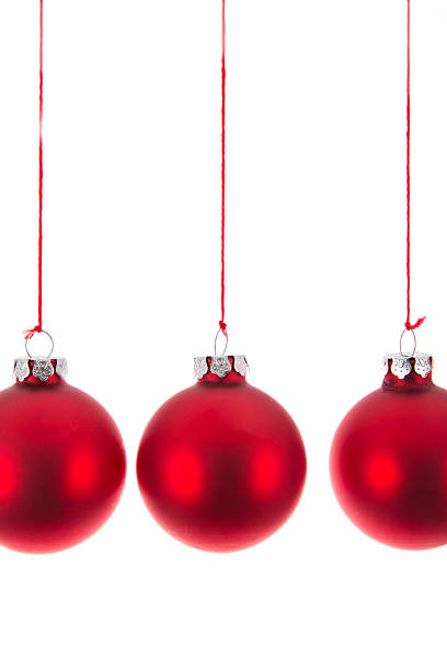 istock Three hanging Christmas balls at a white background 527658339