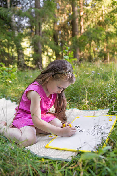 istock little girl drawing 527660859