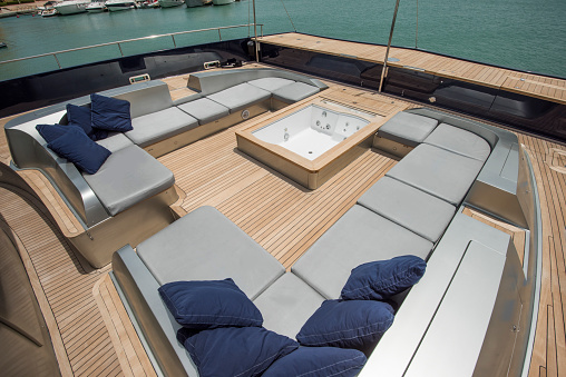 Front deck relaxation area of a large luxury motor yacht with seating area and hot tub