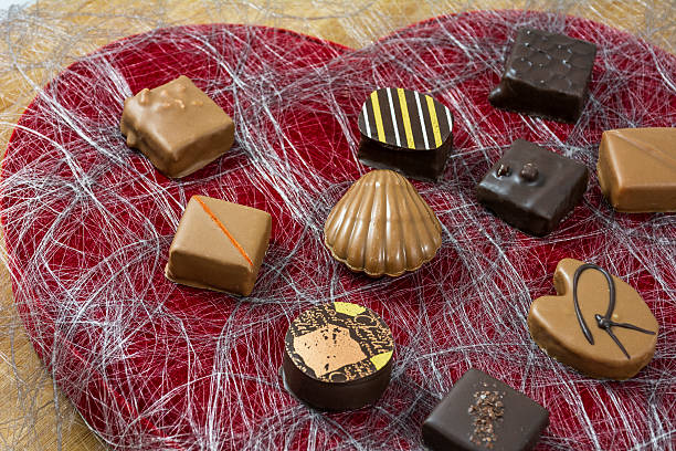 istock Several milk and dark chocolate candies on the heart shape 527662954
