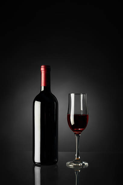 istock Glass of red wine and bottle 527663038