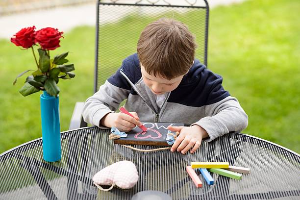 istock Little boy child drawing a love declaration 527663050