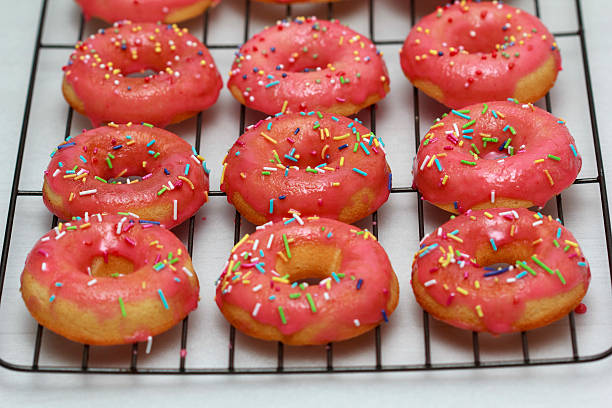istock Pink icing doughnut with Sprinkles Isolated on White Background 527664332