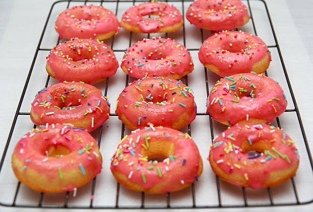 istock Pink icing doughnut with Sprinkles Isolated on White Background 527664802