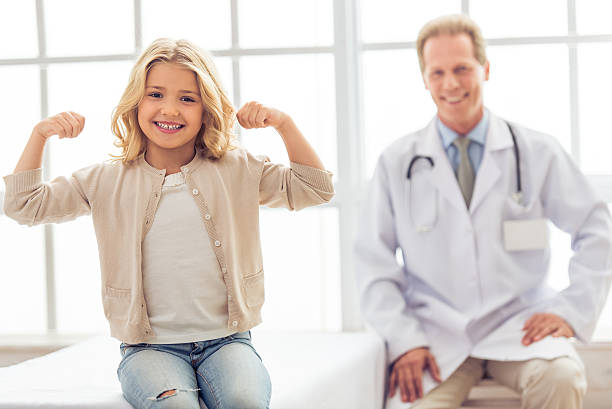 istock Little girl and pediatrician 527665392