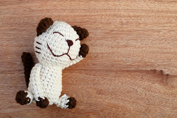 istock cat doll on wooden background 527665688