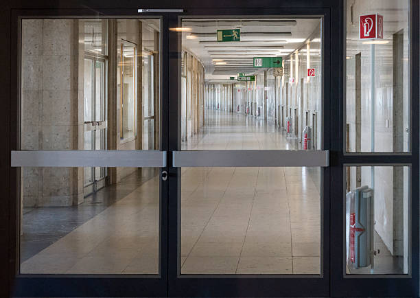 istock Desolate corridor with large glass doorways 527668448