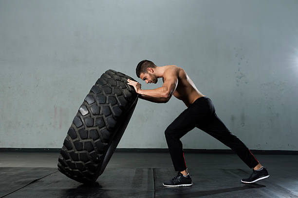 istock Bodybuilder flipping tire at the gym 527671306
