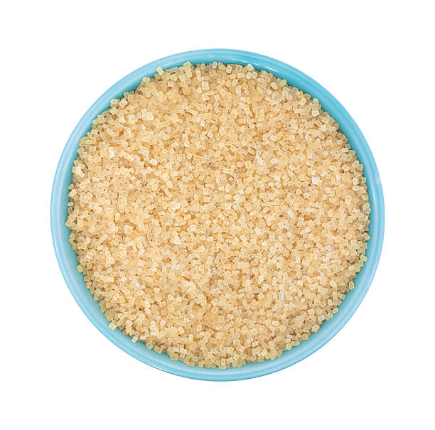 istock Bowl filled with turbinado sugar on a white background 527672572