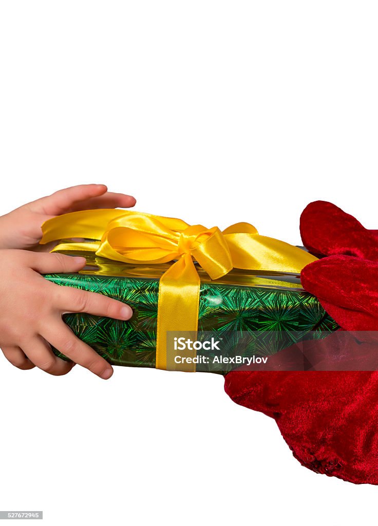 Satna passes the gift to the hands of child Hands of Santa gives a decorated Christmas gift to the hands of child. Horizontal on white background Box - Container Stock Photo