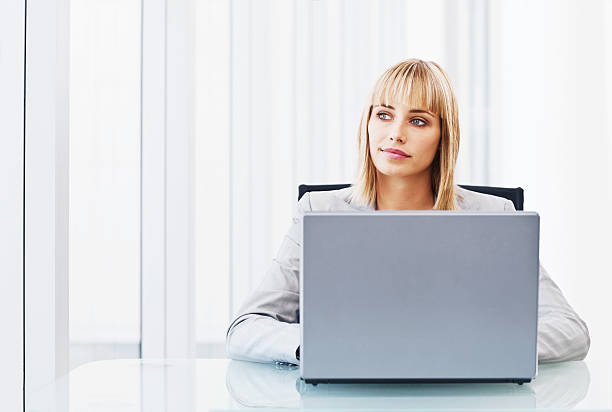 istock Business woman with laptop in office thinking over something 527673025