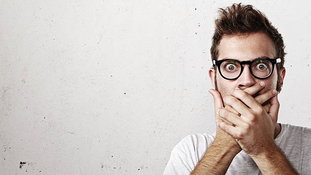 istock Shocked man covering his mouth with hands 527673173