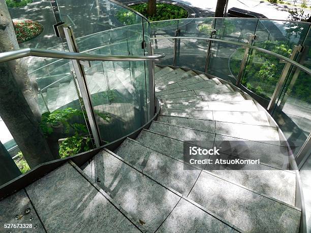 The Spiral Staircase In The Sunlight Filtering Through Trees Stock Photo - Download Image Now