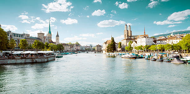 Panoramic view of historic Zurich city center with famous Fraumu Panoramic view of historic Zurich city center with famous Fraumunster and Grossmunster Churches and river Limmat, Switzerland zurich photos stock pictures, royalty-free photos & images