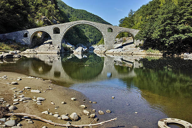 istock Reflection of Devil's Bridge in Arda river and Rhodopes mountain 527674920