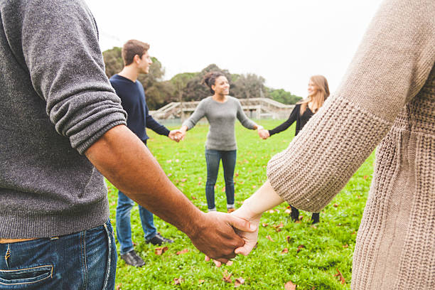istock Multiethnic Group of Friends Holding Hands in a Circle 527676645