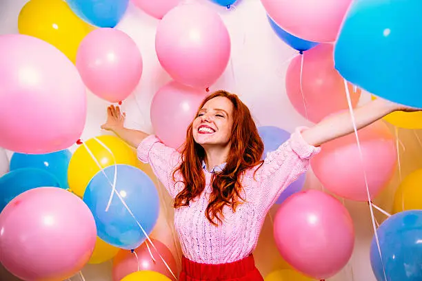 Photo of Young Woman Standing In Many Balloons