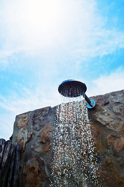 Water is pouring from cheap summer street tap. Service and services of hotels near pool and on beaches concept