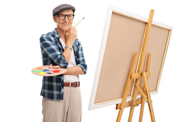 istock Senior artist posing next to a canvas 527679068