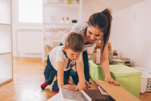 Mommy's little helper Cute, little boy and his mom preparing their stuff for moving t shirt transfer stock pictures, royalty-free photos & images
