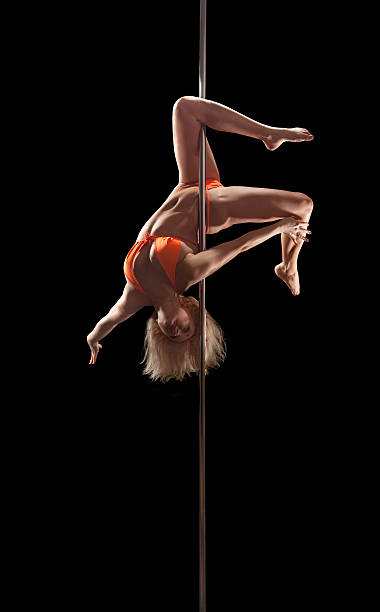 istock Pole dancer performing, show of strenght and flexibility 527679348