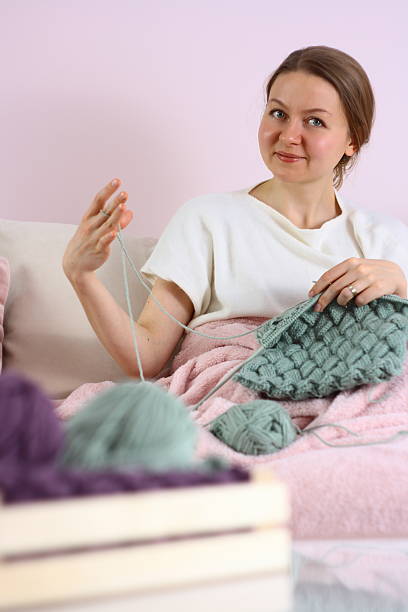 istock young woman knitting 527679547