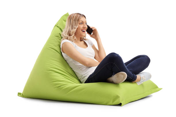 istock Woman talking on phone seated on beanbag 527679640