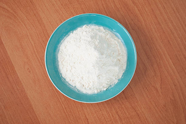 istock Flour in a plate on a wooden table 527679681