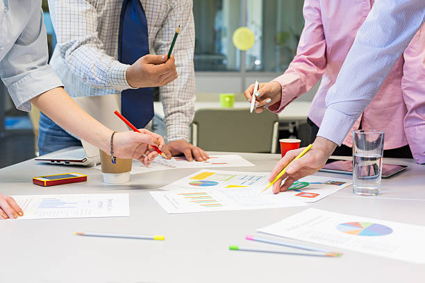 istock Business Team networking office Table with Charts and People Hands 527679876