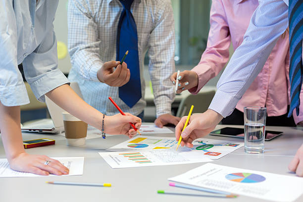 istock Business Team networking office Table with Charts and People Hands 527680046