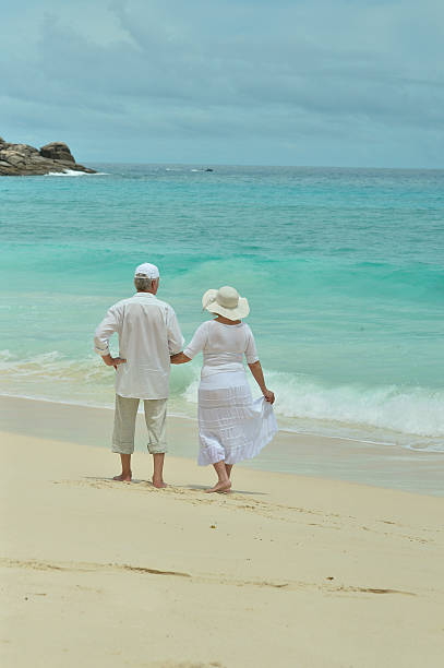 istock elderly couple rest at tropical beach 527680338