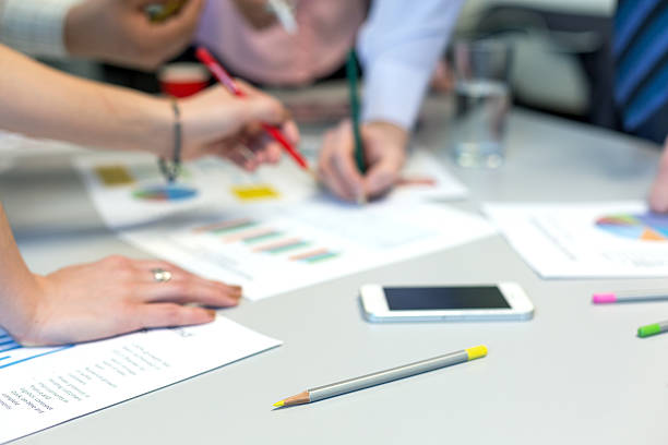istock Business Team networking office Table with Charts and People Hands 527680464