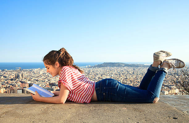Girl reading overlooking the city