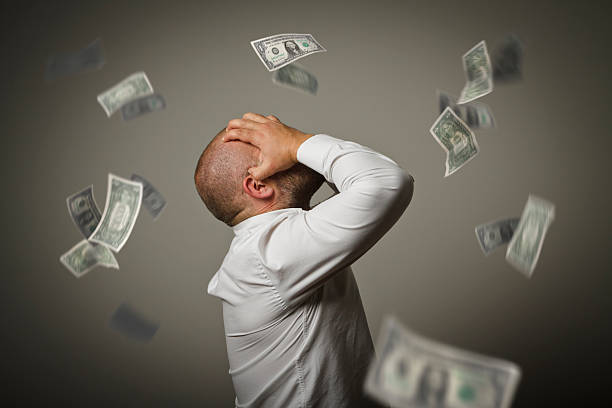 istock Grief. Man in thoughts and dollars. 527681202