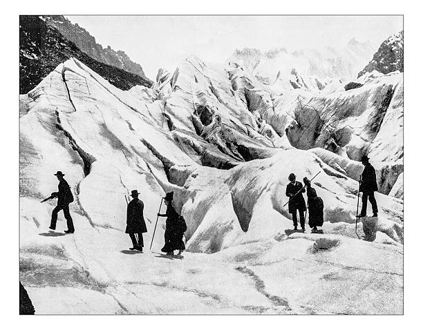 Antique photograph of 19th century mountaineer at Eismeer-Jungfraujoch (Switzerland) Antique photograph of 19th century mountaineer at the Eismeer ("Sea of Ice"), part of the glacier of Jungfraujoch glacier pass (Switzerland): a group of six men and women equipped with walking canes and in formal 19th century wearing apparel walking on the ice and snow switzerland photos stock illustrations