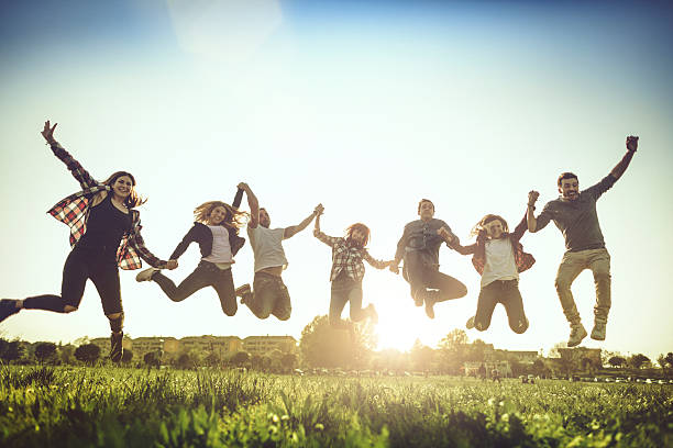 istock Friends jump together with raised arms 527682454