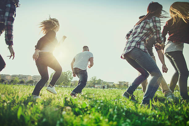 istock Friends running together on a green field 527682522