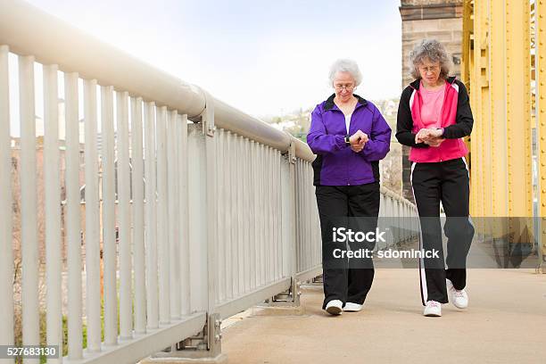 Women Checking Fitness Watches As They Walk Stock Photo - Download Image Now - Pedometer, Pittsburgh, People