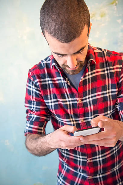 istock Casual Dress Man Texting on smart phone 527684992