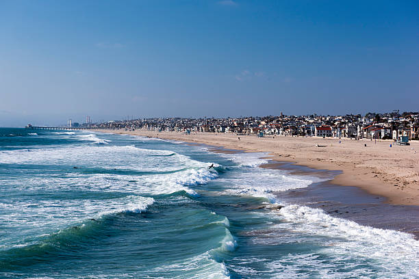 Manhattan Beach, Los Angeles, California, USA. Sea waves and city view.
