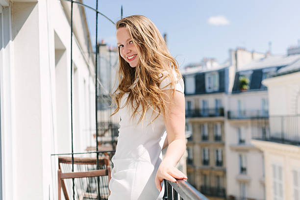 istock Woman on a balcony in Paris 527688184