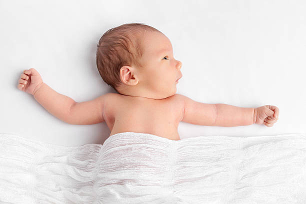istock Cute newborn baby under a blanket 527688232