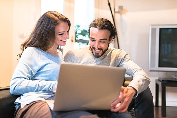 istock French couple using the laptop at home 527688396