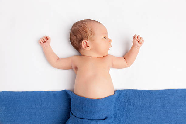 istock Cute newborn baby under a blanket 527688428