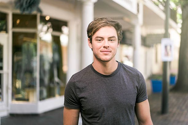 istock Confident young man standing outside shop 527689232