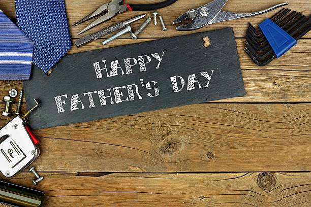 istock Happy Father's Day greeting on slate with border of tools 527690814