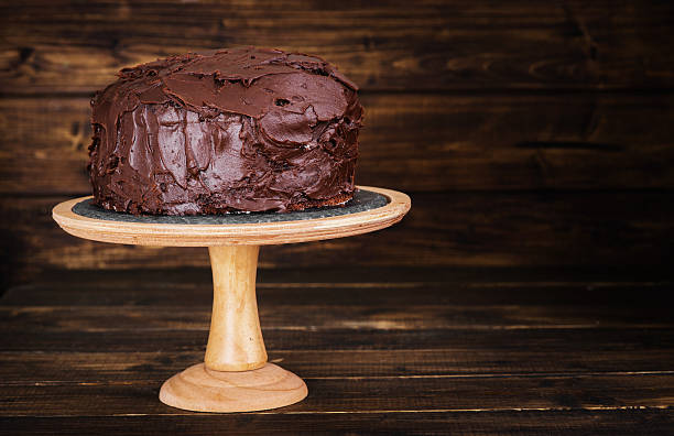 istock Chocolate cake on dark wooden bckground 527691014